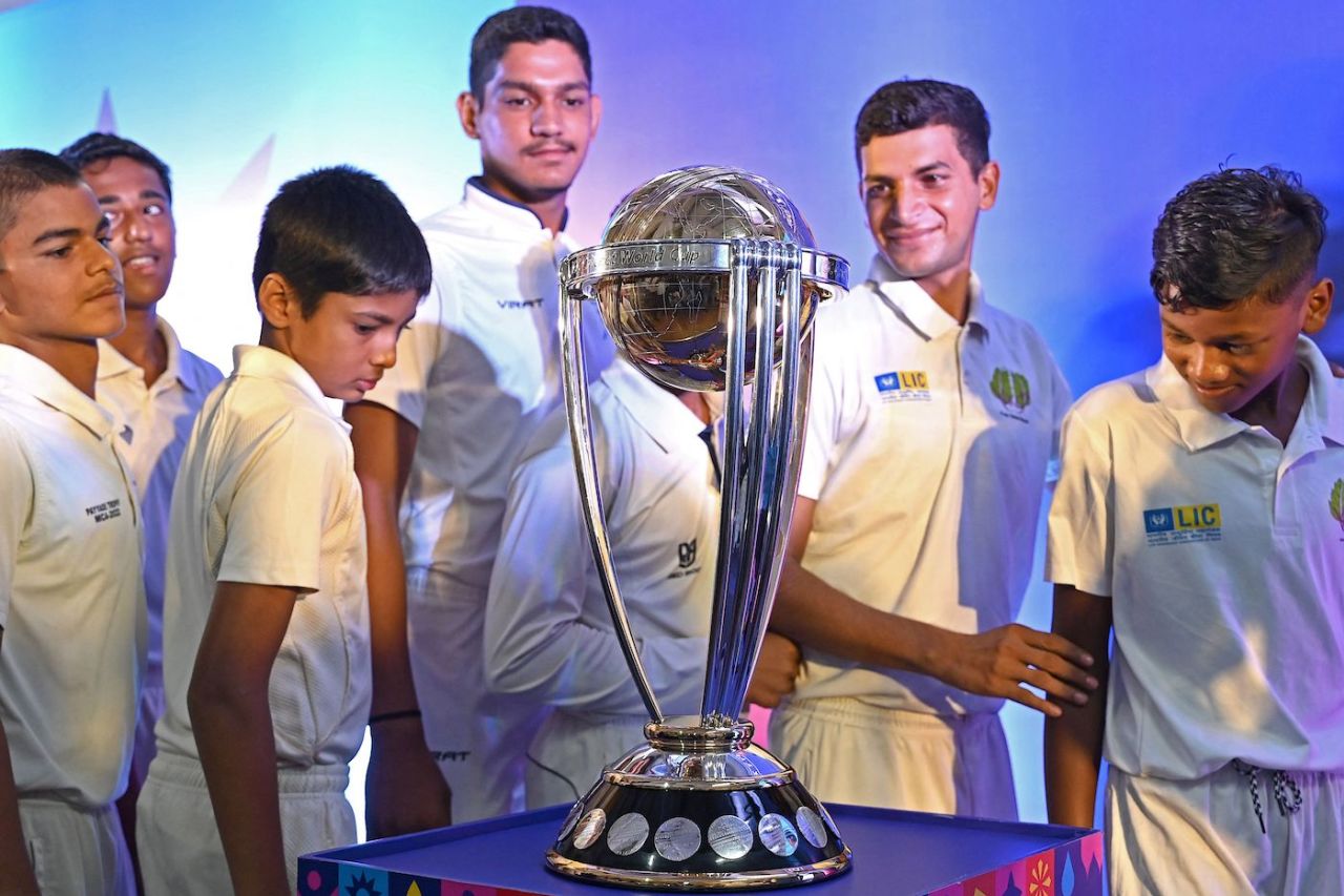 Young boys with the World Cup trophy in Mumbai, July 4, 2023