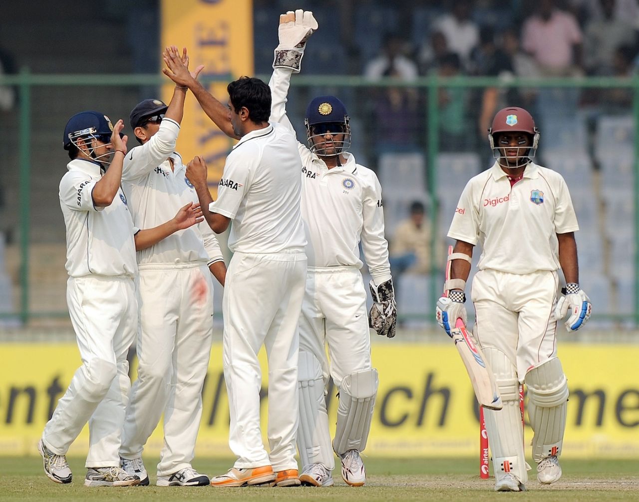 R Ashwin celebrates with his teammates after taking the wicket of Shivnarine Chanderpaul, India vs West Indies, 1st Test, Delhi, 3rd day, November 8, 2011