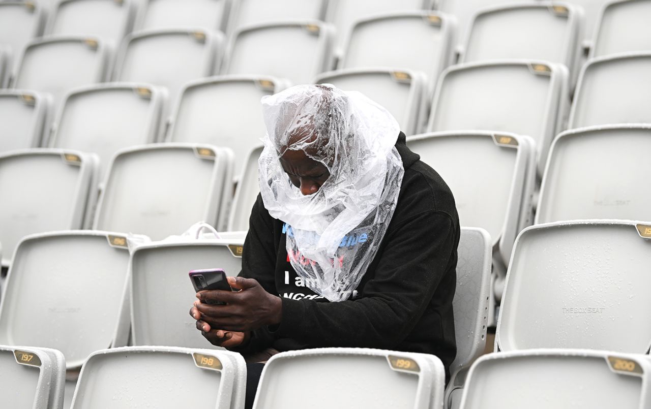 A fan in the stands check his phone for updates, England vs Australia, 4th Ashes Test, Old Trafford, 5th day, July 23, 2023