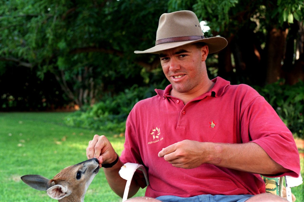 Heath Streak feeds a young springbok on his farm,