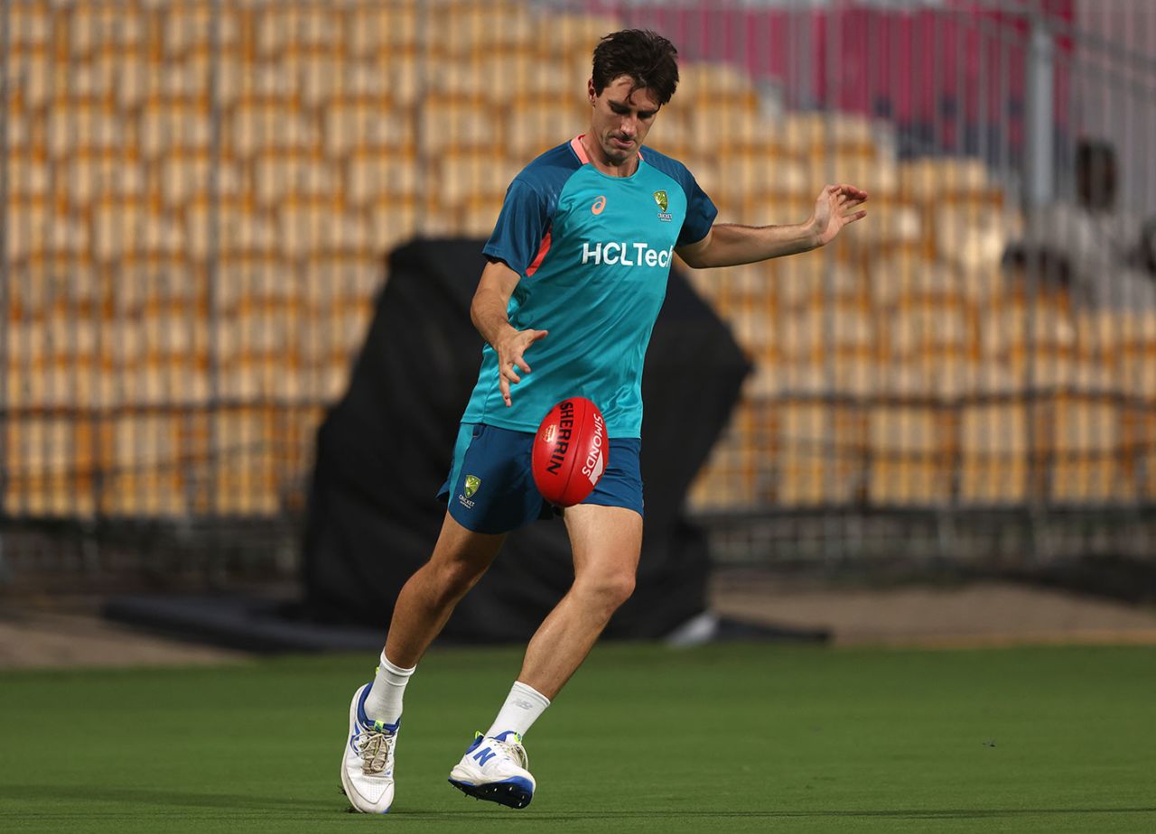 Pat Cummins kicks a football during training, Chennai, October 5, 2023