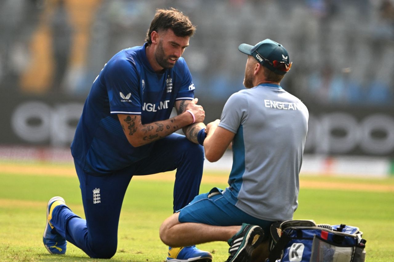Reece Topley received the physio's attention on his injured finger before walking off, England vs South Africa, Men's World Cup 2023, Mumbai, October 21, 2023