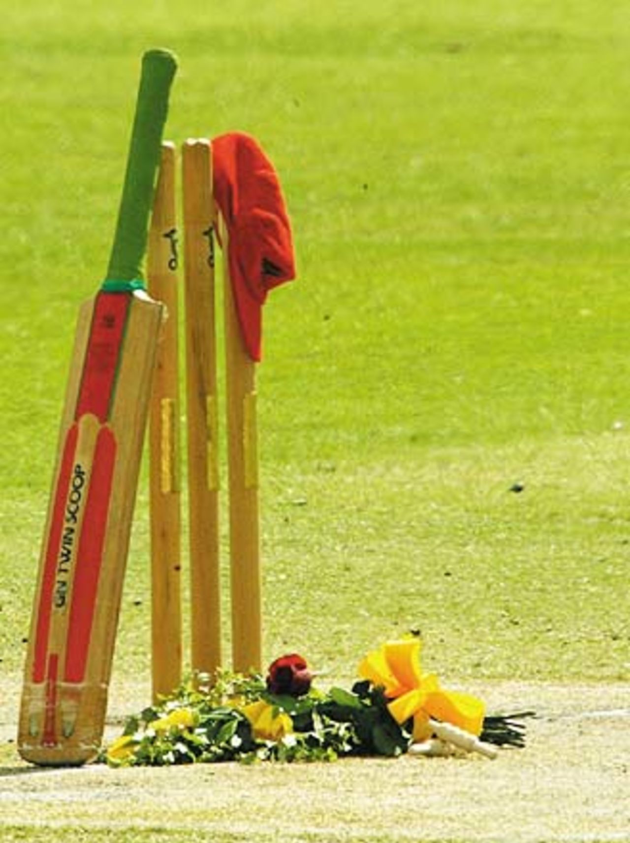 The set of stumps used in David Hookes' last game as well as a bat and red cap are arranged in tribute, Adelaide, January 27, 2004