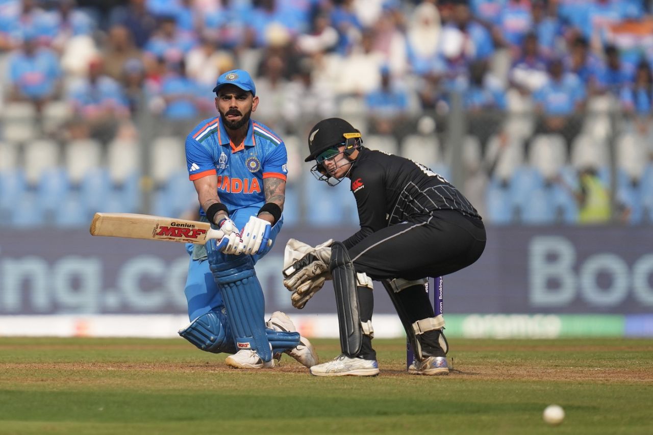 Virat Kohli plays a paddle sweep with Tom Latham looking on, India vs New Zealand, ICC Men's World Cup 2023, 1st semi-final, Mumbai, November 15, 2023