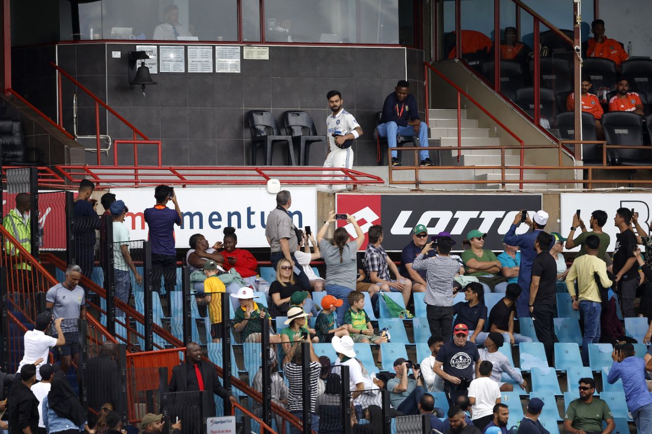 The action in the middle is forgotten as Virat Kohli, all kitted up, makes his way out at Rohit Sharma's fall, South Africa vs India, 1st Test, Centurion, 1st day, December 26, 2023