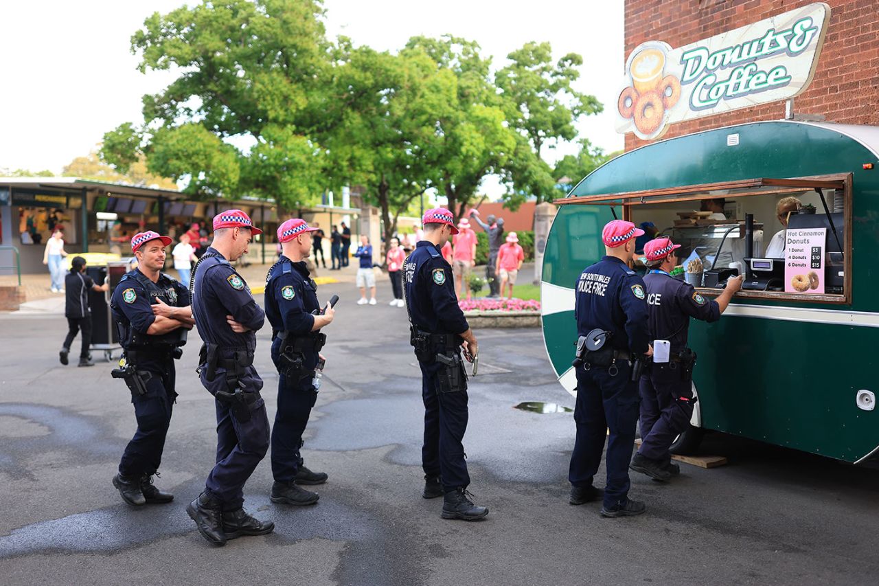 Police queue for their morning coffee wearing pink caps, Australia vs Pakistan, 3rd Test, SCG, January 5, 2024