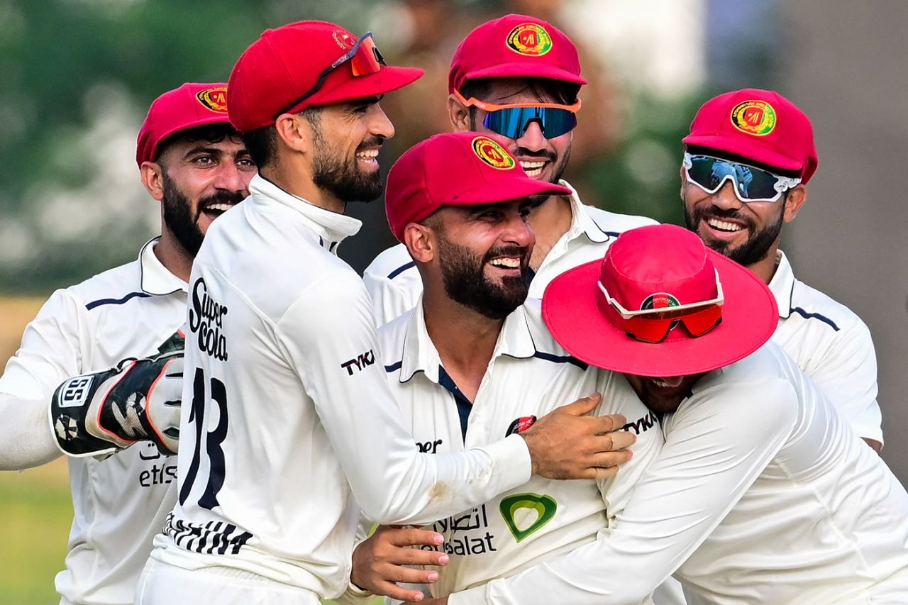 Hashmatullah Shahidi is mobbed by team-mates after his direct hit took care of Dhananjaya De Silva, Sri Lanka vs Afghanistan, Only Test, Colombo, 2nd day, February 3, 2024