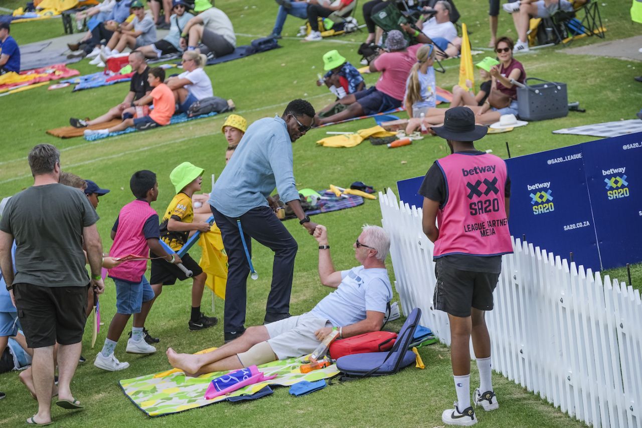 Pommie Mbangwa fistbumps a fan on the Johannesburg grass banks, Joburg Super Kings vs Paarl Royals, Johannesburg, SA20, Eliminator, February 7, 2024