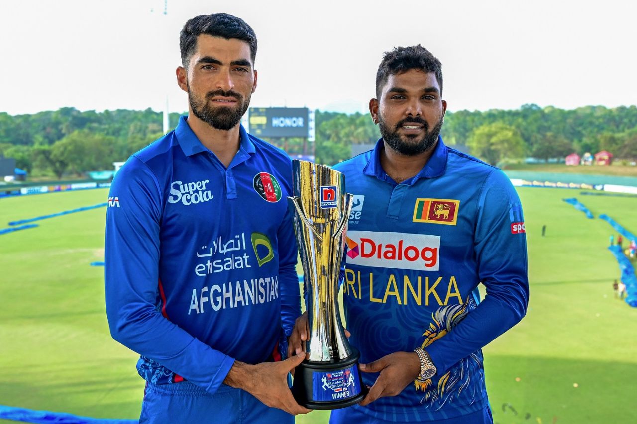 Ibrahim Zadran and Wanindu Hasaranga pose with the T20I series trophy, Dambulla, February 16, 2024