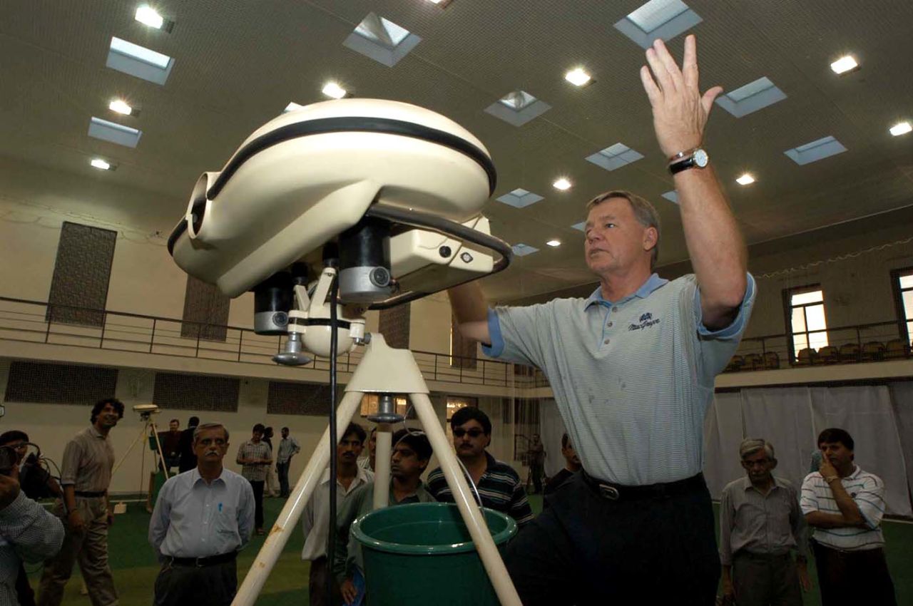 Mike Procter tests a bowling machine at the National Cricket Academy in Lahore, September 14, 2003