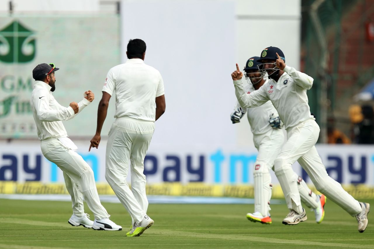 From left, Virat Kohli, R Ashwin, Wriddhiman Saha and Cheteshwar Pujara celebrate the wicket of David Warner, India v Australia, 2nd Test, Bengaluru, 2nd day, March 5, 2017