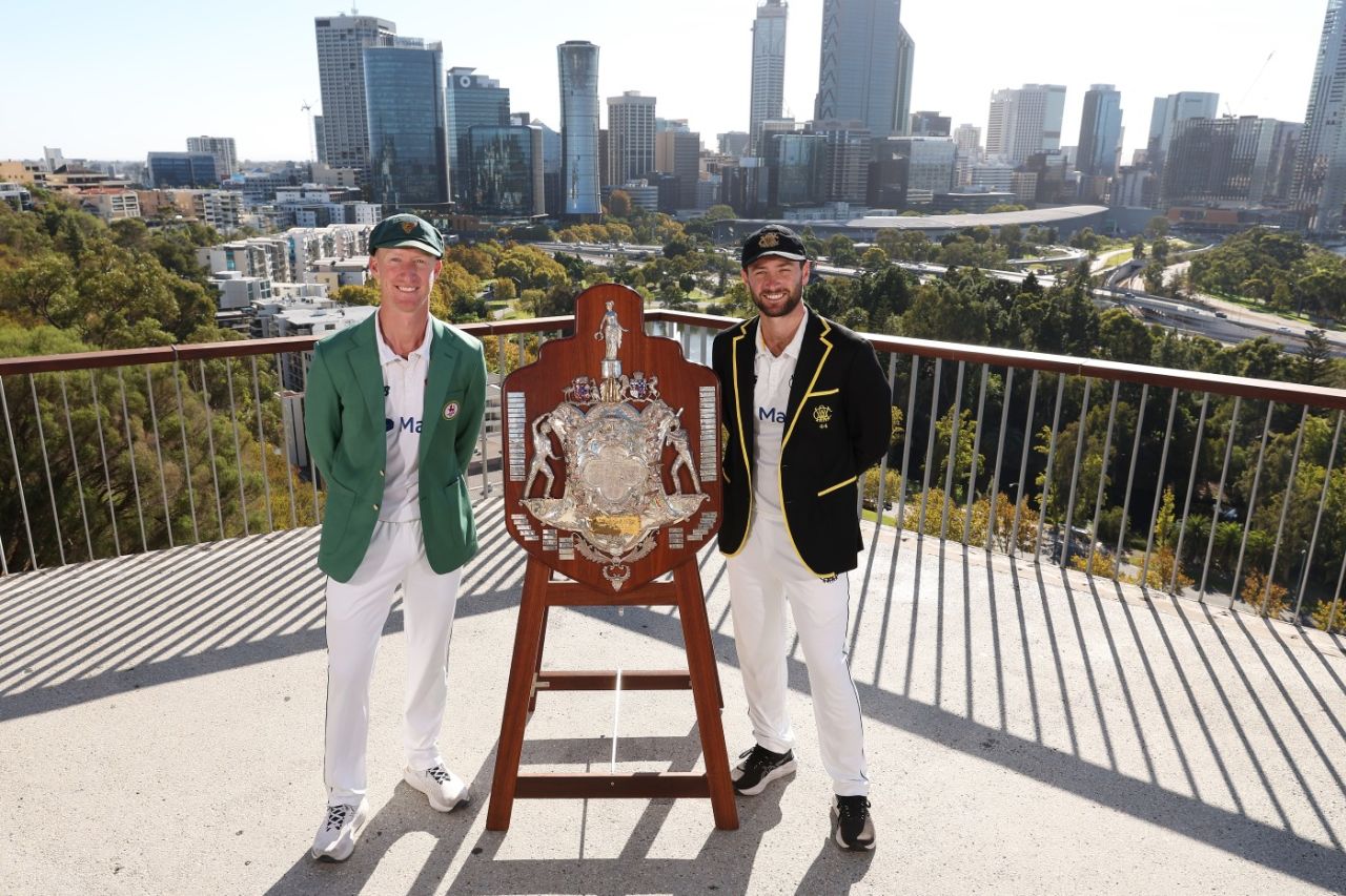 Jordan Silk and Sam Whiteman pose with the Sheffield Shield trophy at King's Park in Perth