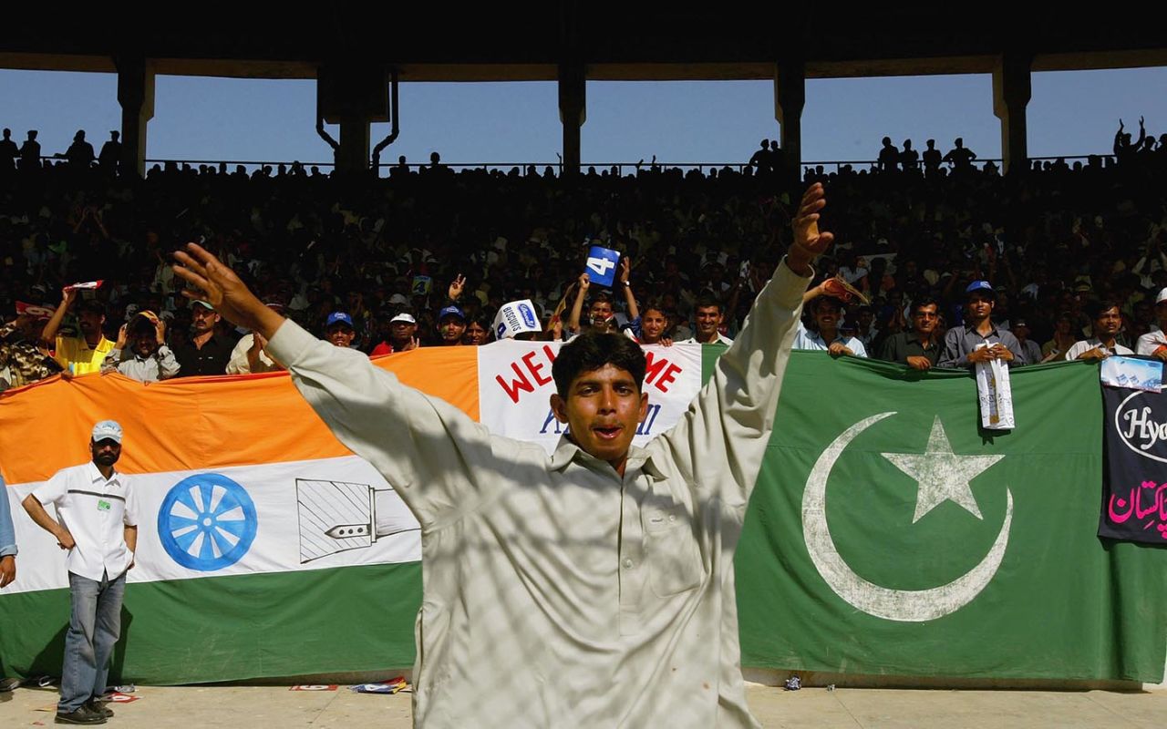 A spectator poses in front of the India-Pakistan flags jointly displayed in front a stand, Pakistan v India, 1st ODI, Karachi, March 13, 2004