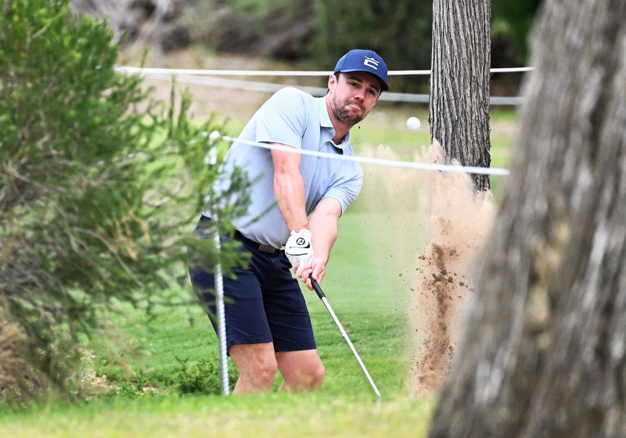 Travis Head hits out of the rough at the Grange Golf Club, Adelaide, April 20, 2023