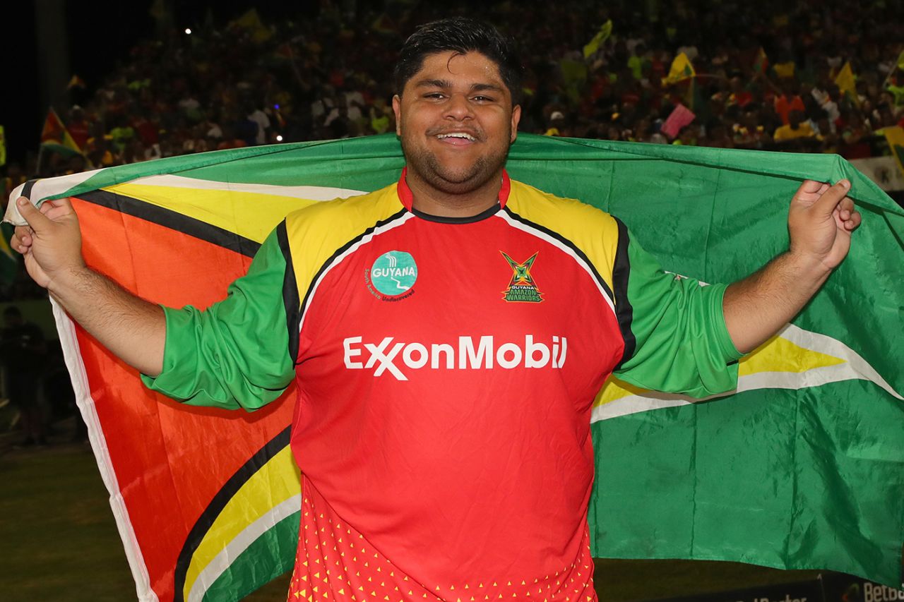 Azam Khan poses with the Guyana flag | ESPNcricinfo.com