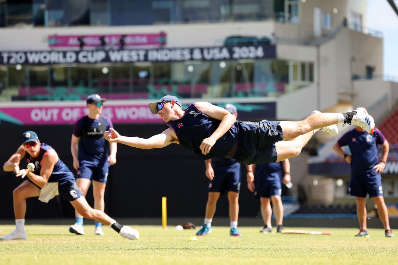 Brandon McMullen gets airborne during catching practice ahead of Scotland's match against Oman in Antigua, June 8, 2024