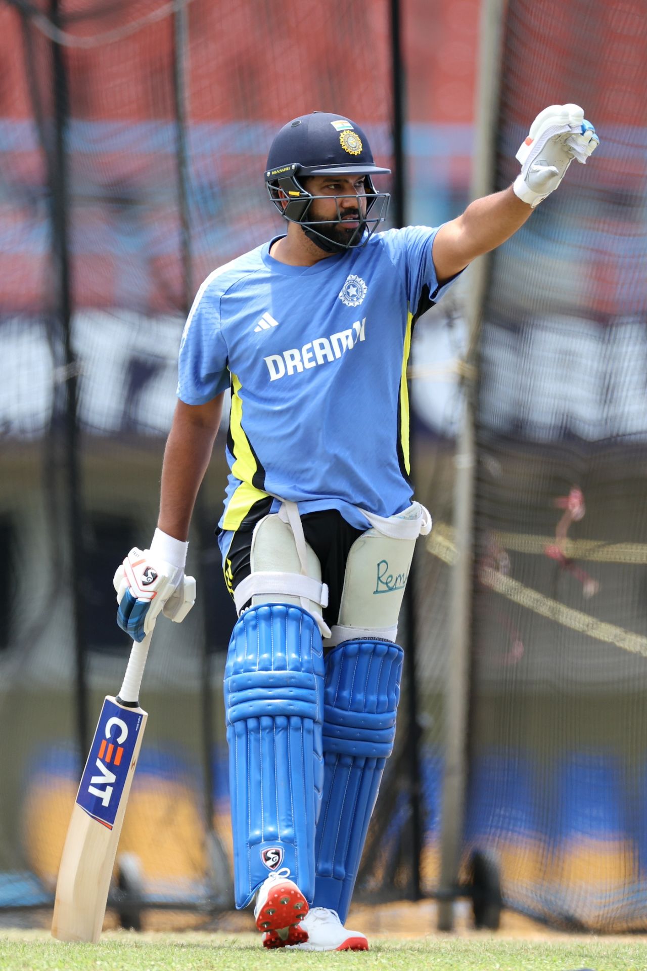 Rohit Sharma signals during a stint in the nets ahead of India's Super Eight match against Bangladesh, T20 World Cup, Antigua, June 21, 2024