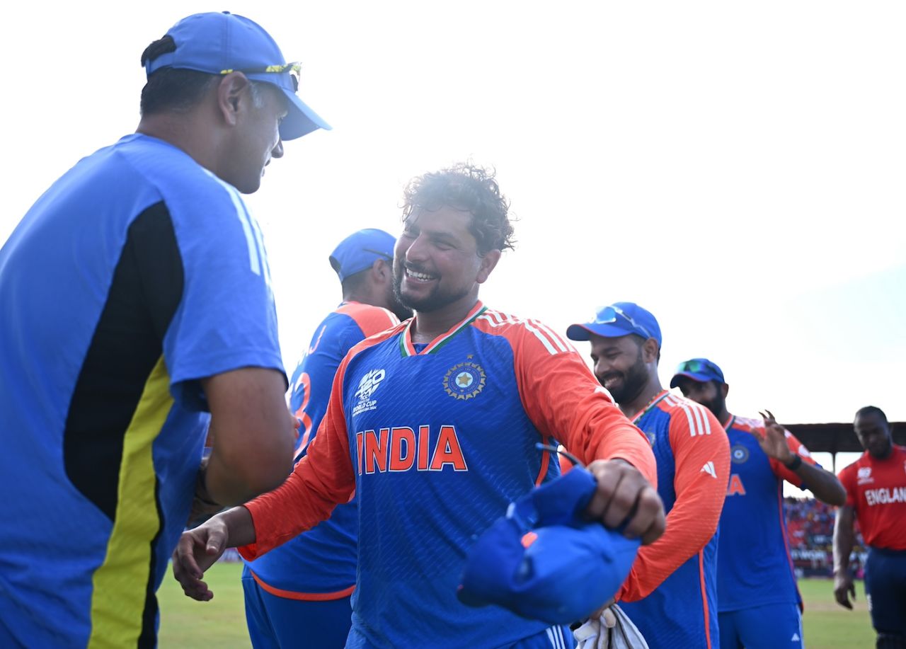 Smiles all around as the Indians - Rahul Dravid and Kuldeep Yadav in this case - celebrate a job well done, England vs India, T20 World Cup semi-final, Providence, Guyana, June 27, 2024