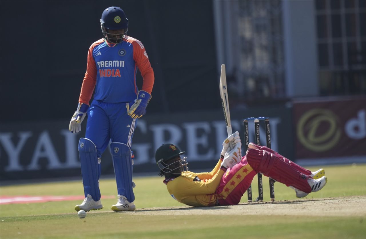 Wessly Madhevere ends up on the floor as Sanju Samson watches on, 4th men's T20I, Harare, July 13, 2024