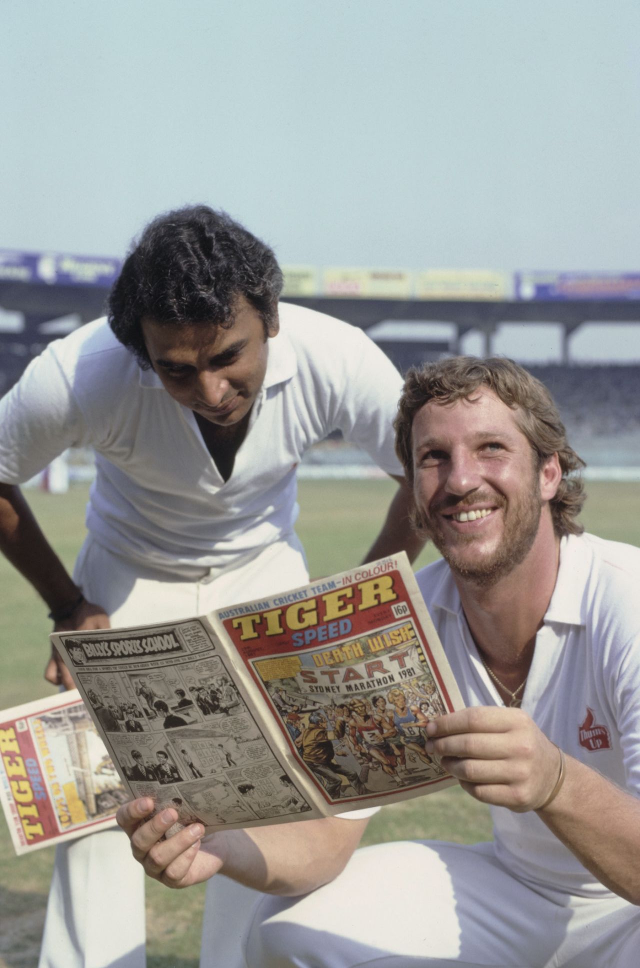 Sunil Gavaskar and Ian Botham share a joke as they read a copy of the children's sport comic Tiger and Speed, India, Feb 12, 1982