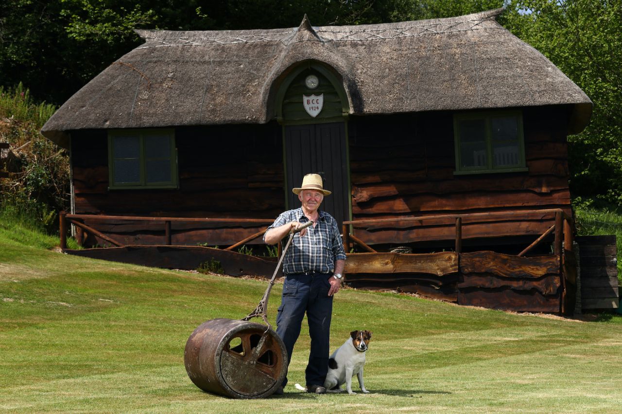 Doug Sherring the groundsman of 67 years at Bridgetown Cricket Club poses with his dog Jack outside the club's pavillion, May 28, 2020