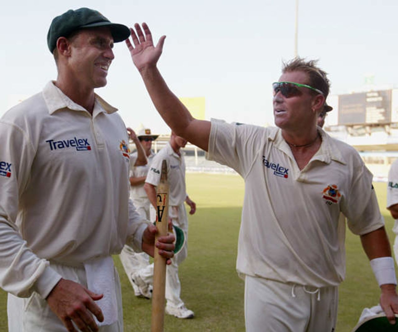 Australian spin bowler Shane Warne (R) celebrates winning the second cricket test match against Pakistan with high scoring batsman Matthew Hayden, carrying one of the stumps, at Sharjah's stadium October 12, 2002. Pakistan crumbled to defeat in less than two days of the second test against Australia on Saturday, adding just 53 to their first innings 59 and losing by an innings and 198 runs. Pakistan's match total of 112 was the fourth worst in test history.