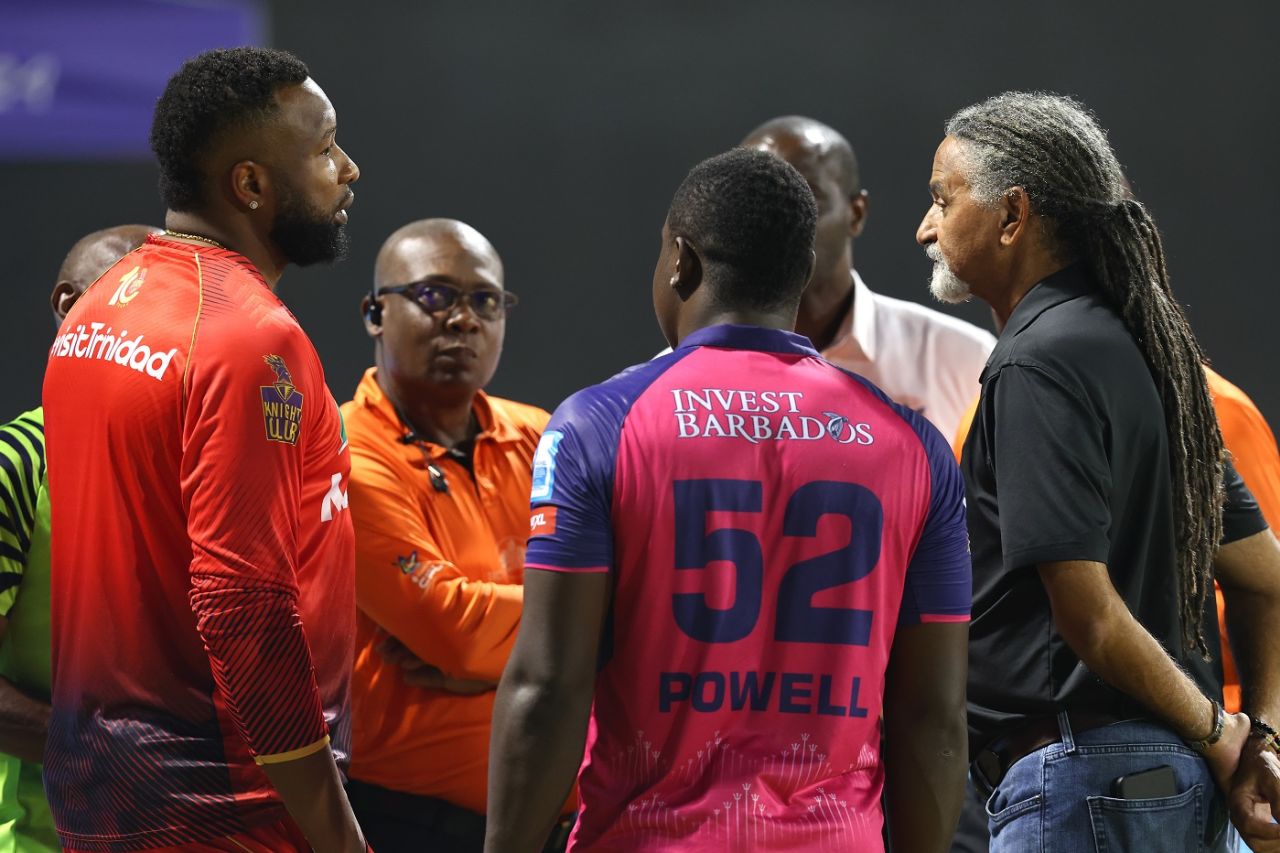 Kieron Pollard and Rovman Powell have a chat with match officials after a floodlight failure stopped play, Trinbago Knight Riders vs Barbados Royals, Eliminator, CPL 2024, October 1, 2024