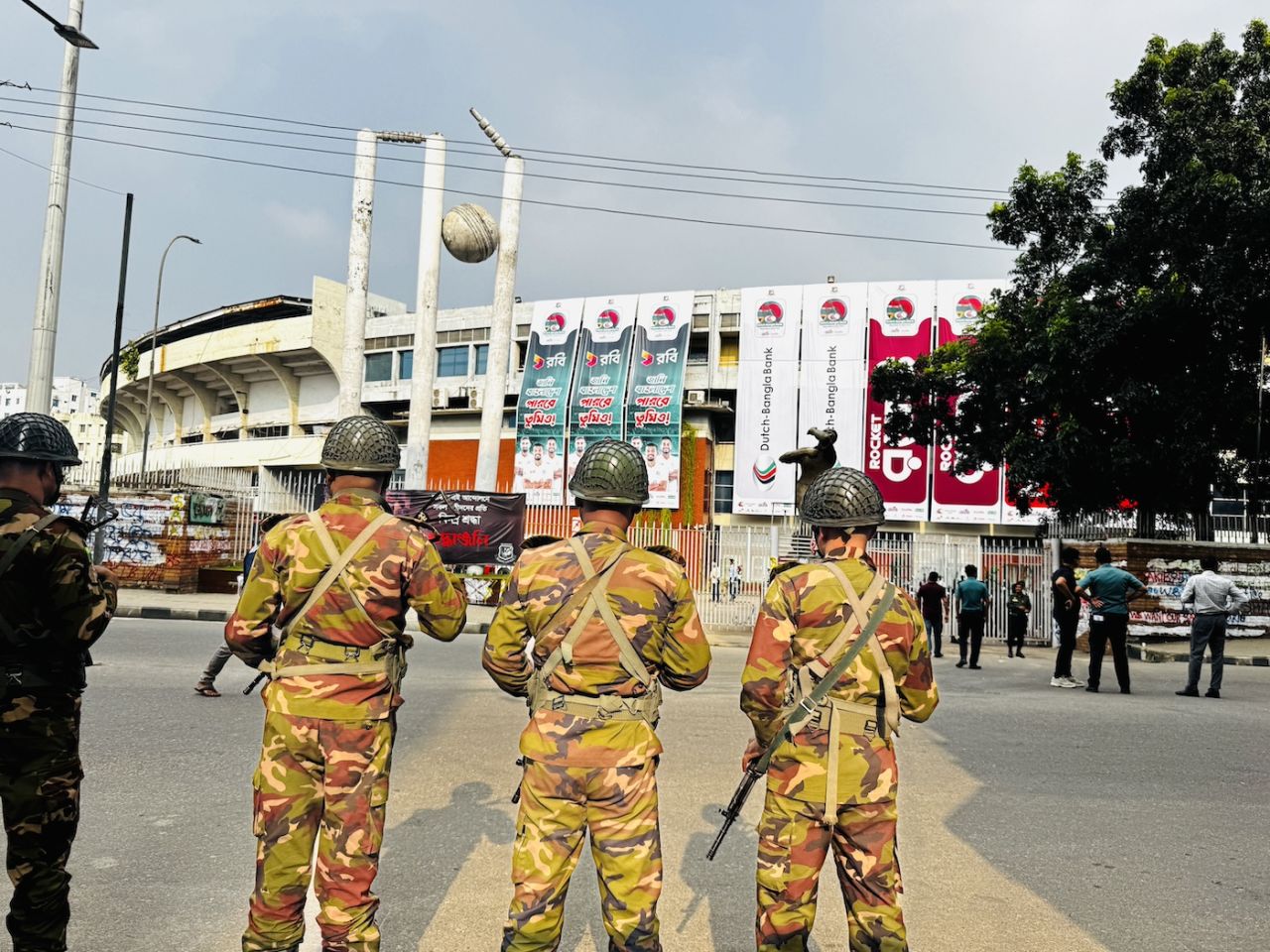 Security officials stand guard outside the Shere Bangla National