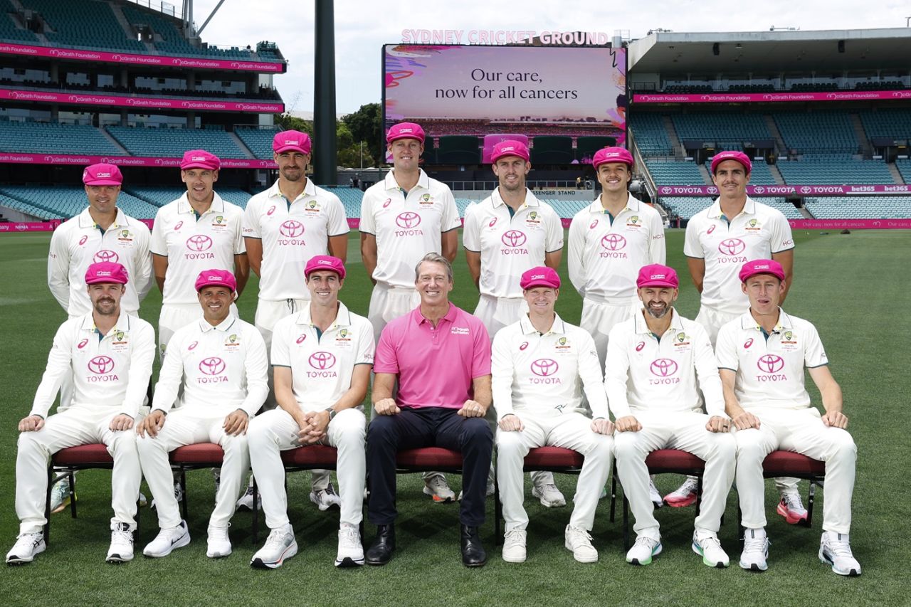 Pat Cummins and some his teammates, in their Pink Test gear, inspect