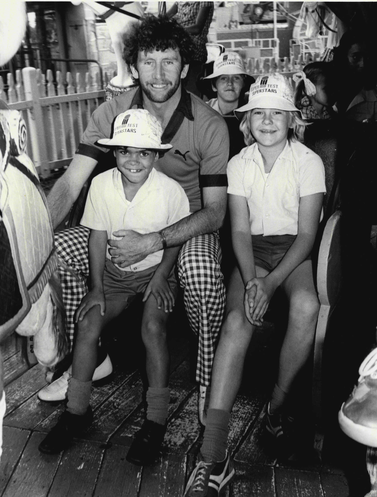 Ian Chappell spends the day at Luna Park with kids from a children's home, Sydney, December 14, 1978