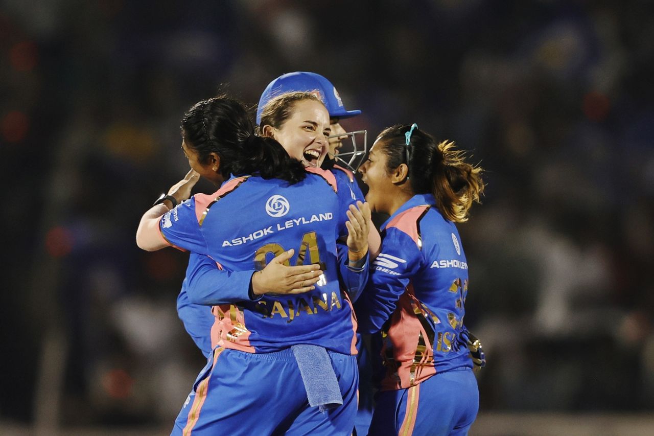 Amelia Kerr is mobbed by her team-mates after striking in her first over, Mumbai Indians vs Delhi Capitals, WPL 2025, final, Mumbai, March 15, 2025