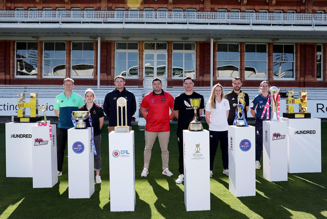 Sam Billings, Lucy Higham, Dan Douthwaite, Anthony Clapham, Rory Burns, Emily Windsor, Jack Taylor and Saskia Horley pose with the domestic trophies at the ECB's season launch, Lord's, April 1, 2025