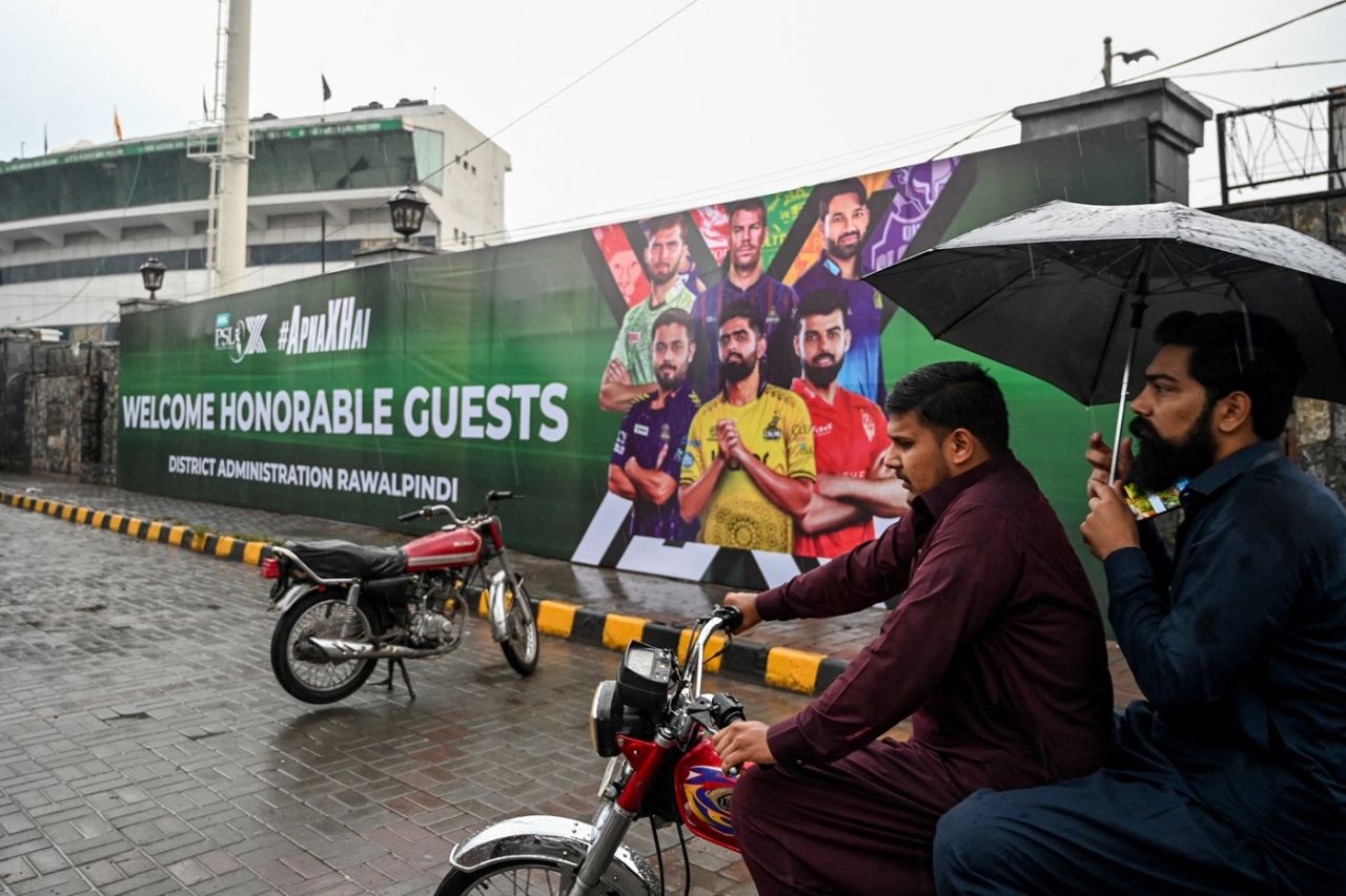Men ride on a motorbike in front of the Rawalpindi cricket stadium after an alleged drone was shot down, Rawalpindi, May 8, 2025