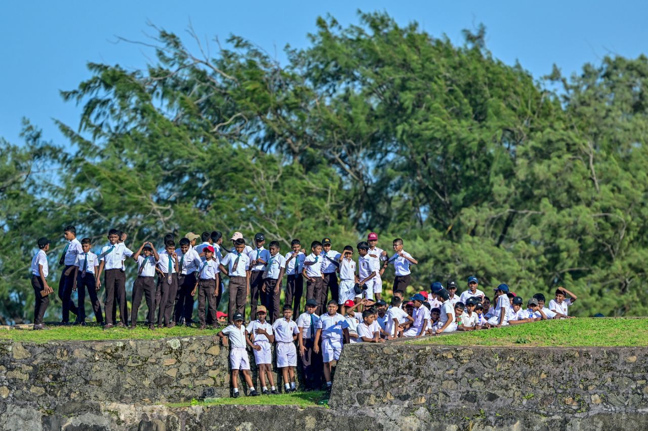 Schoolkids watch the cricket from the grass banks, Sri Lanka vs Bangladesh, 1st Test, Galle, day 4, June 20, 2025