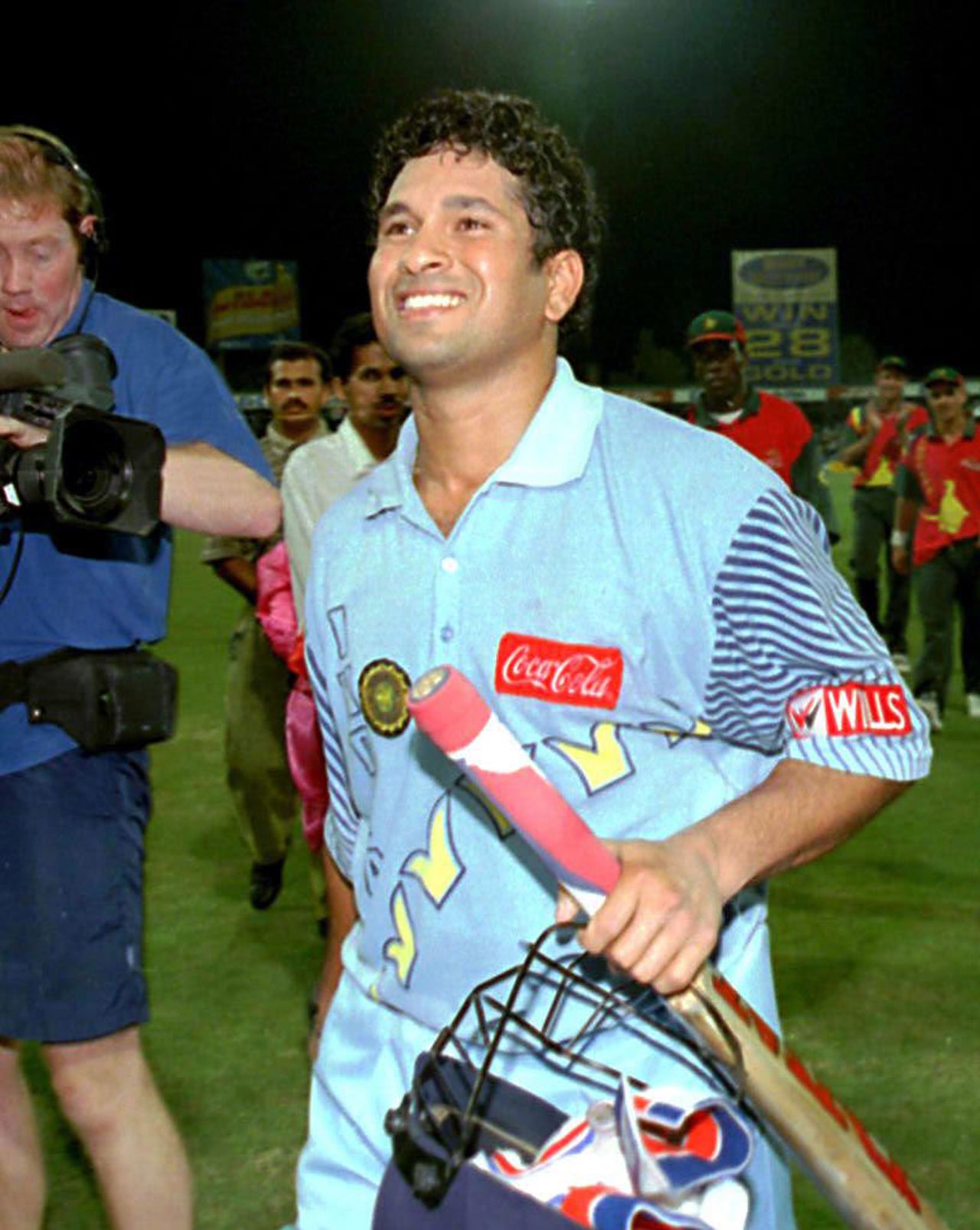 India's Sachin Tendulkar enjoys a moment of glory after leading  his te am to victory at the  Coca Cola Trophy in Sharjah 13 November. India beat Zimbab we by 10 wickets in the final of the week-long tournament. World champions Sri L anka failed to register a single victory. Tendulkar scored a century with 6 sixe s in today's match and was named man-of-the-tournament.
