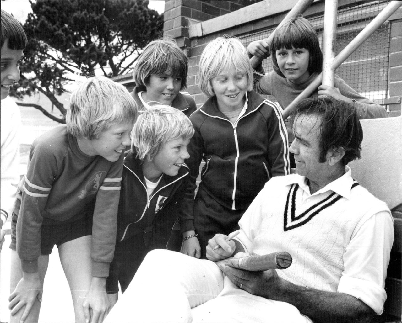 Bob Simpson signs autographs on a cricket bat for some local children, Waverley, October 22, 1977