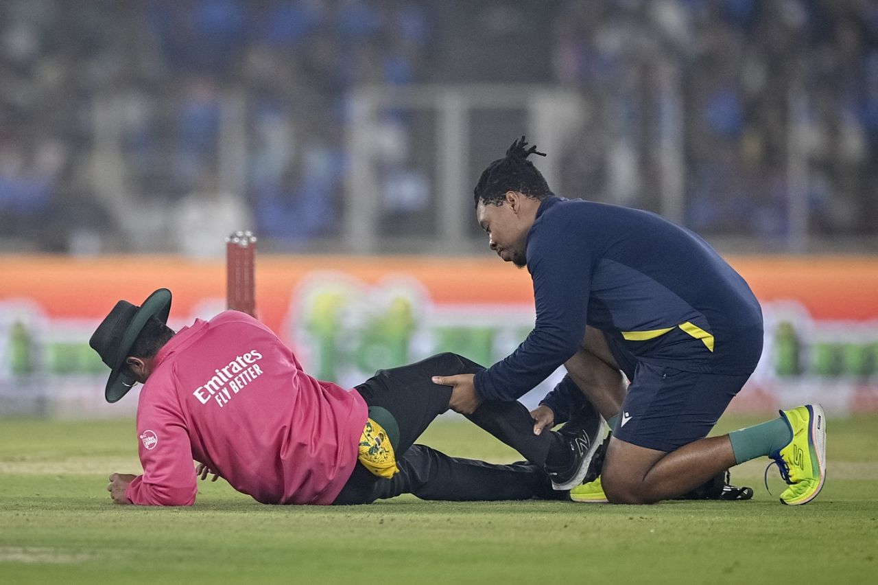 Umpire Rohan Pandit gets some attention from South Africa's physio after taking a blow to his shin, India vs South Africa, 5th T20I, Ahmedabad, December 19, 2025