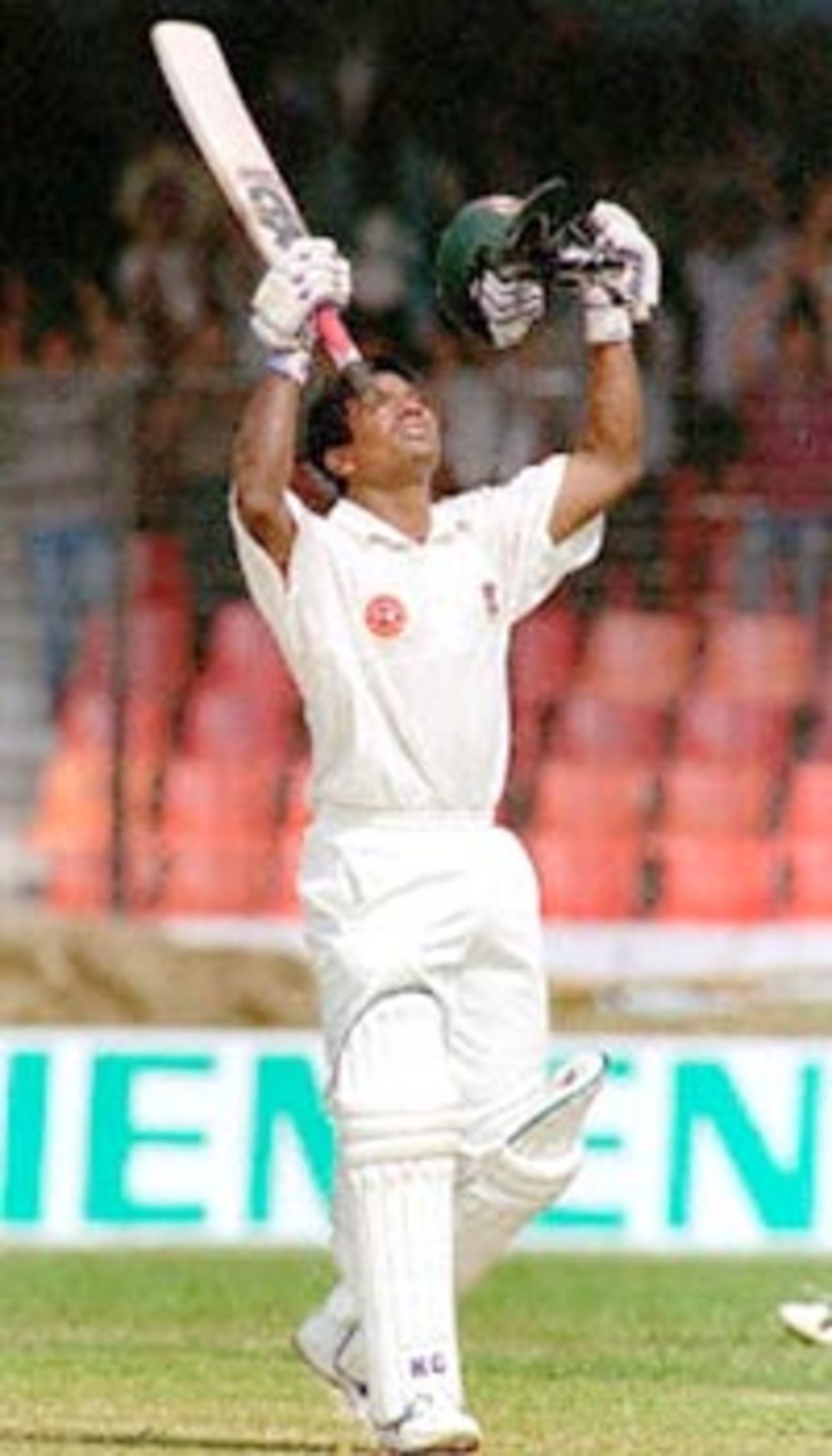 Bangladeshi batsman Aminul Islam raises his hands to celebrate after hitting a century 11 November 2000 at the Bangabandhu National Stadium on the second day of Bangladesh's inaugural test match against India. Aminul created history by becoming the third man to score a century in an inaugural test match. Bangladesh scored 302 for six at lunch on the day in their debut match.