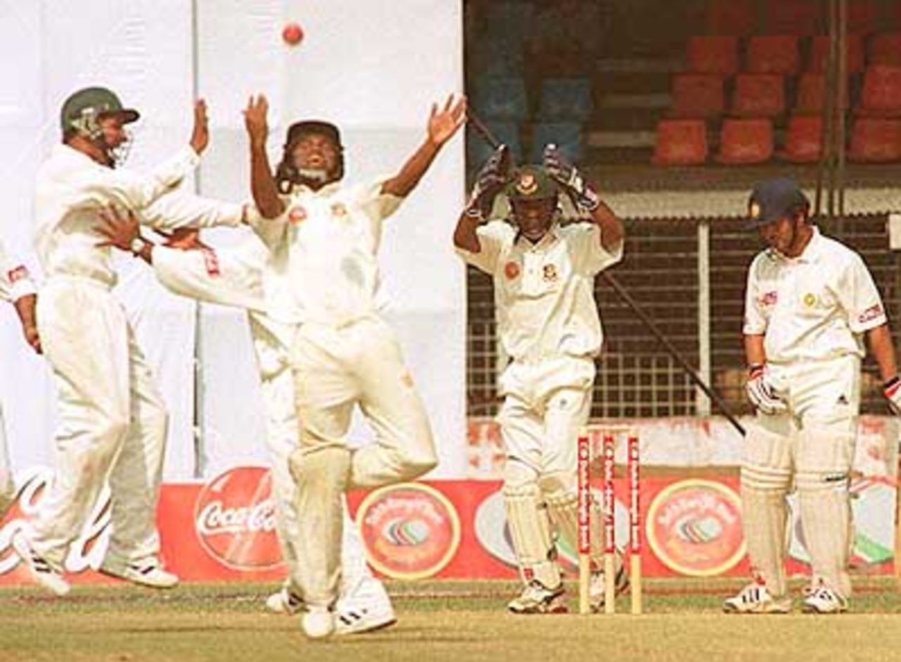 Jubiliant Bangladesh close in fielders after the fall of Tendulkar. India in Bangladesh 2000/01, Only Test, Bangladesh v India Bangabandhu National Stadium, Dhaka, 10-14 Nov 2000 (Day 3)
