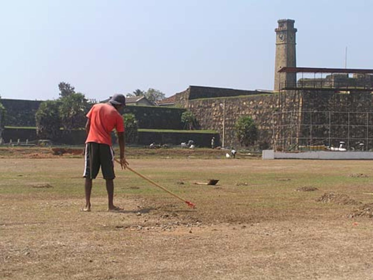 Groundstaff rake stones of the Galle outfield, January 19, 2005