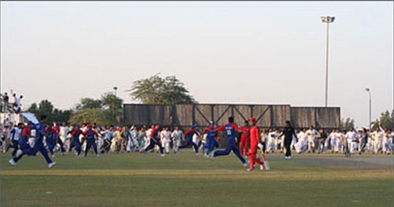 Chaotic scenes after the last ball in the ACC Twenty20 final between Afghanistan and Oman. The match finished tied and the pitch was so cut up by spectators that a bowl-out was considered impossible, Afghanistan v Oman, ACC Twenty20 Cup final, Kuwait, November 2, 2007