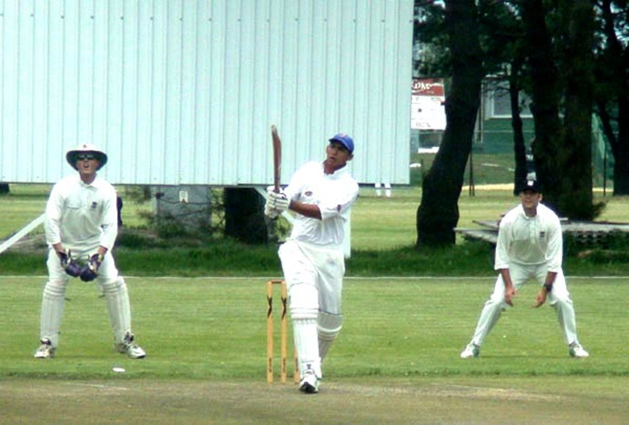 Wesley Euley of St. Augustines pulls a delivery from Marcel le Roux of Northerns Goodwood to the mid wicket boundary. Looking on are wicketkeeper Wimpy Louw and 1st slip Marco Bennandew.