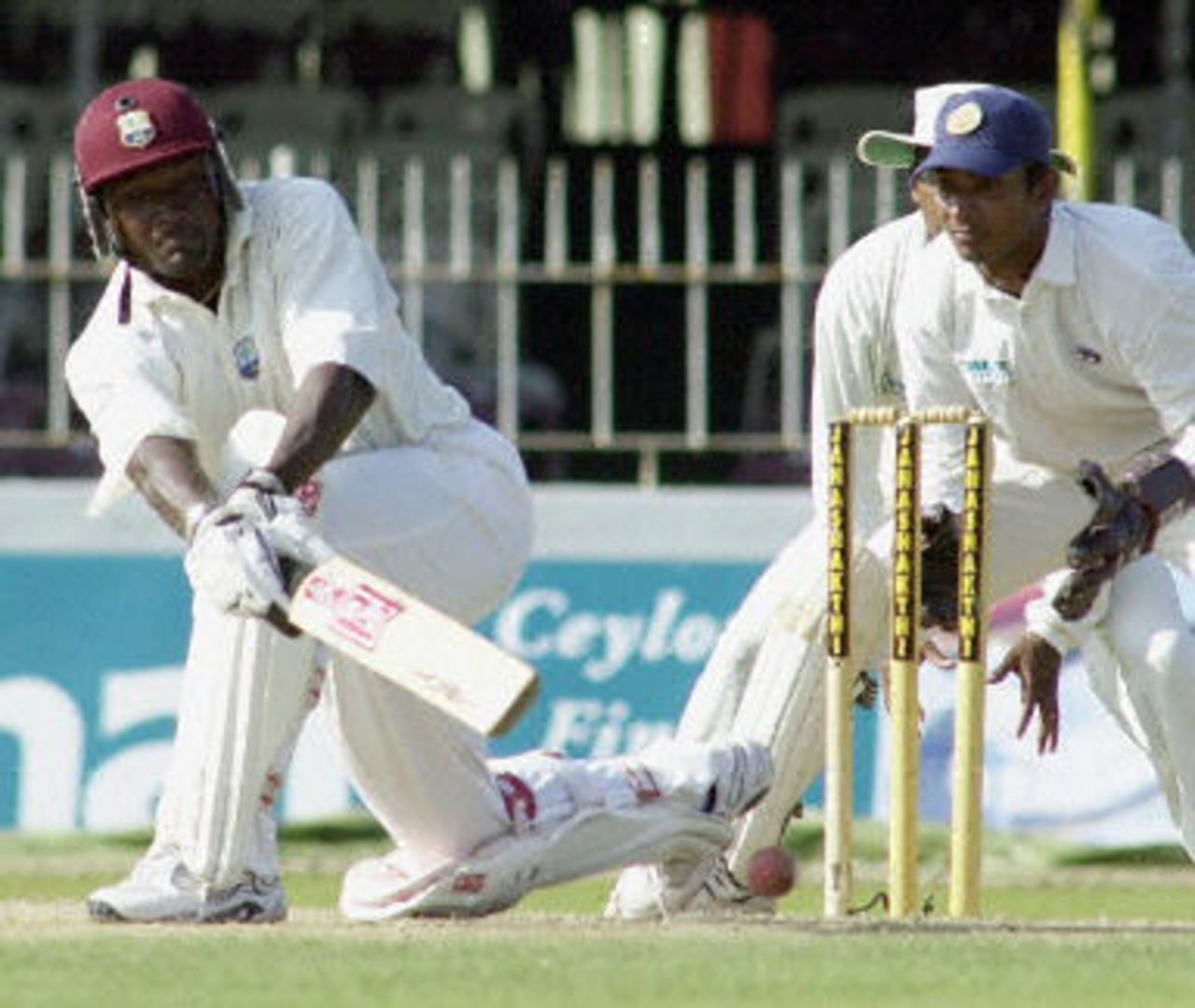 West indies skipper Carl Hooper sweeps a ball as wicket keeper Kumar Sangakkara looks on