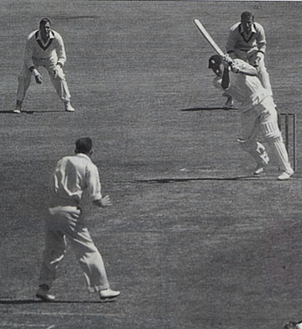 Peter May, on his way to a century in the Sydney Test, drives Bill Johnston, with Archer and Hole hopeful at slip. May's partner is Colin Cowdrey, who made 54 in their crucial stand of 116, December 21, 1954