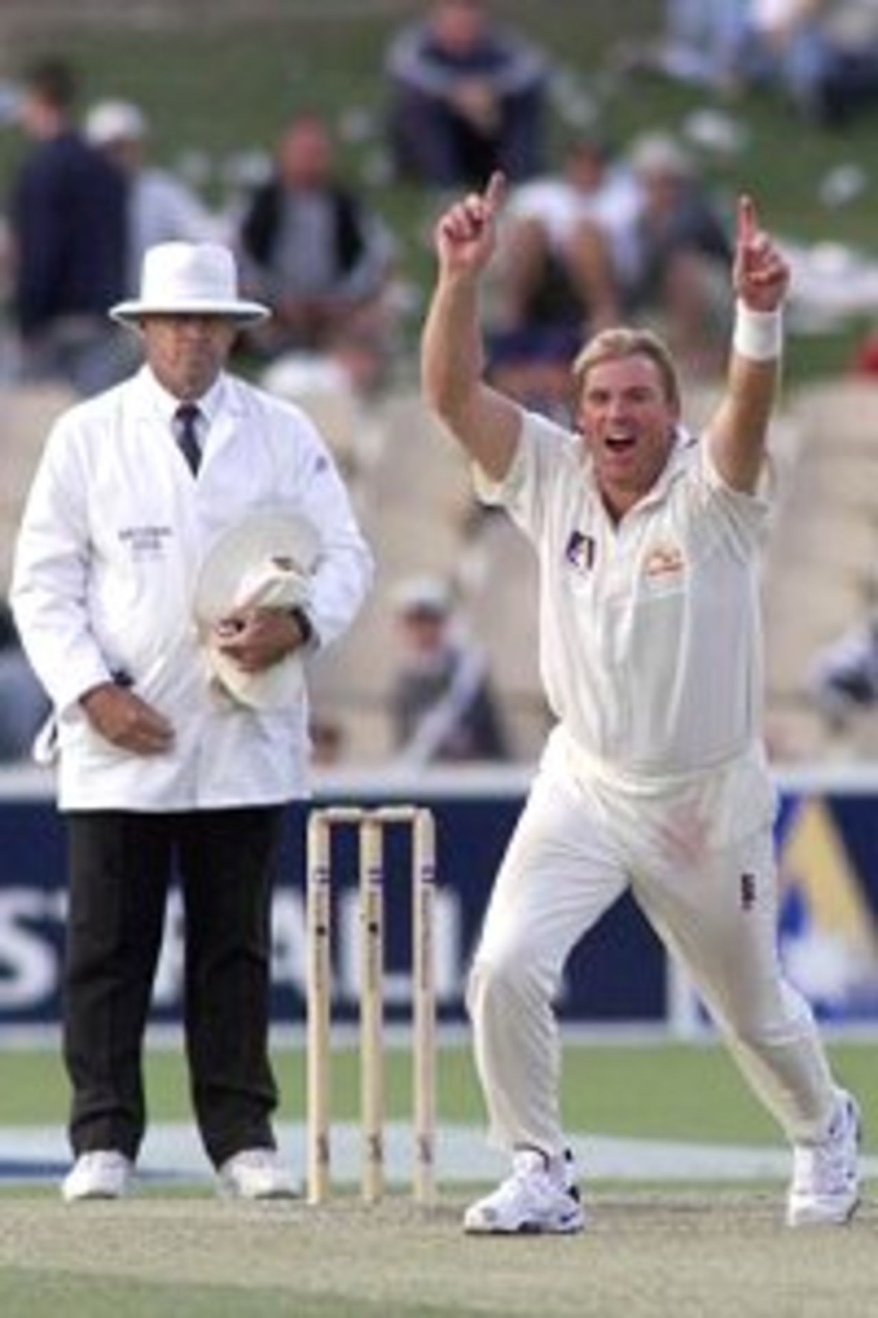 11 Dec 1999: Shane Warne of Australia celebrates the wicket of Rahul Dravid of India with umpire Daryl Harper looking on, on day two of the first test between Australia and India, at the Adelaide Oval, Adelaide, Australia.