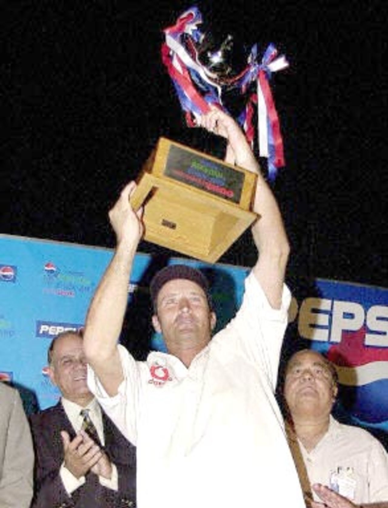 English captain Nasser Hussain holds aloft the trophy of the Test series after winning against Pakistan by six wickets on the last day of the third cricket Test match at the National Stadium in Karachi, 11 December 2000. England clinched a historic series victory, snatching a stunning win with just minutes to spare in the third and final Test. England's six-wicket triumph makes them the first English side to win a Test in Pakistan since 1962 and end the hosts' unbeaten record in 34 encounters.
