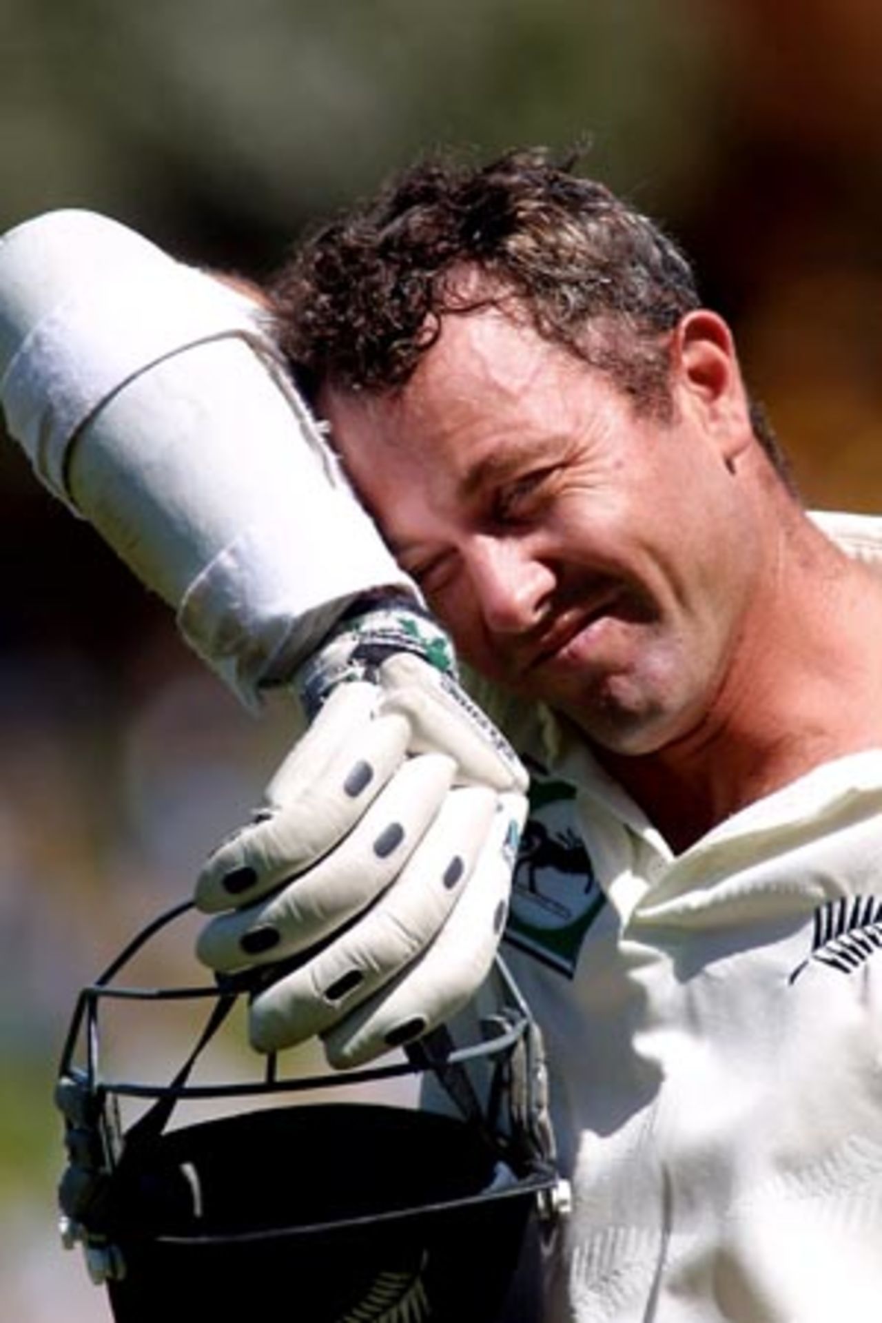 New Zealand batsman Mark Richardson wipes sweat from his forehead after being dismissed for 83, caught by Bangladesh fielder Mashrafe Mortaza from the bowling of Hasibul Hossain. 2nd Test: New Zealand v Bangladesh at Basin Reserve, Wellington, 26-30 Dec 2001 (29 December 2001).