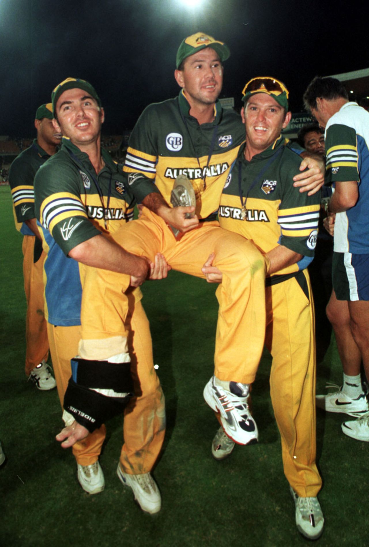 4 Feb 2000: Australian batsman Ricky Ponting, who was named man of the match, is carried from the ground by teammates Damien Martyn (left) and Ian Harvey following their victory over Pakistan in the Carlton and United Breweries one day international second final at the Sydney Cricket Ground, Sydney, Australia.Ponting damaged his ankle whilst fielding and was unable to walk.