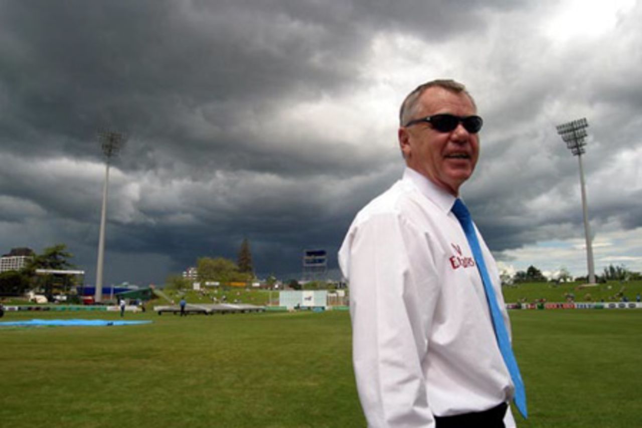 Match referee Mike Procter prepares for rain as dark cloud hovers over the ground. Play was eventually abandoned on day one at 2.45pm. 2nd Test: New Zealand v India at Westpac Park, Hamilton, 19-23 December 2002 (19 December 2002).