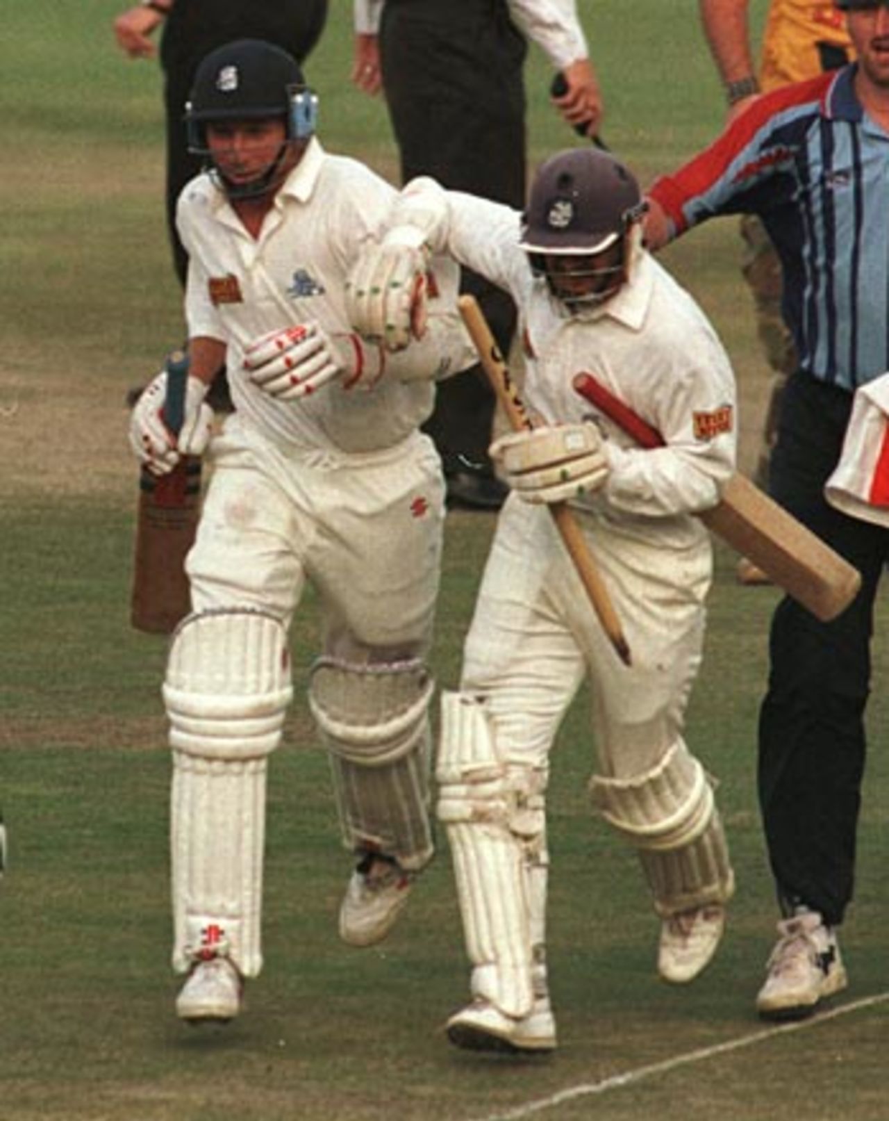 Jack Russell and Mike Atherton rush off at the end of their epic stand, South Africa v England,  Johannesburg, December 4, 1995